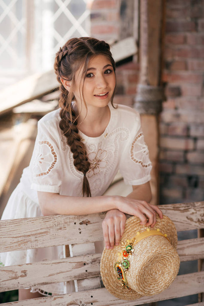 beautiful young woman with two braids and straw hat - Photo, image