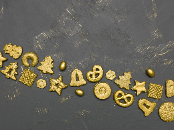 collection of golden christmas cookies on black wooden background - Valokuva, kuva