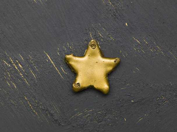 golden christmas cookie on black wooden background, close view  - Valokuva, kuva
