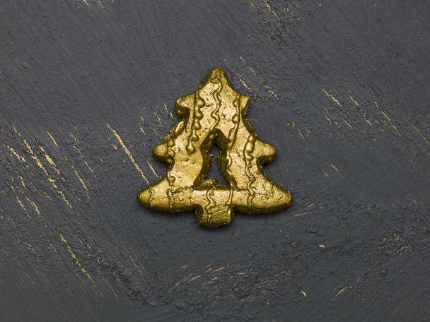 golden christmas cookie on black wooden background, close view  - Foto, Imagen