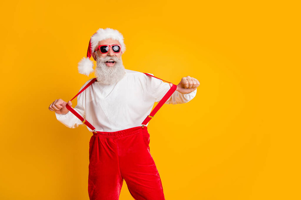 Cool funky santa claus party hard christmas celebration enjoy x-mas newyear time pull suspenders pants shirt isolated over bright color background - Foto, afbeelding