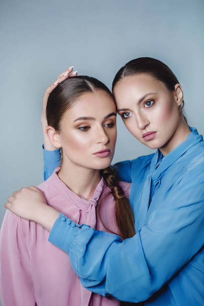 young beautiful women in blue and pink shirts - Fotografie, Obrázek