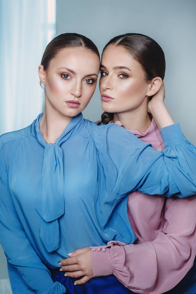 young beautiful women in blue and pink shirts - Фото, зображення