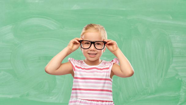smiling cute little girl in glasses at school - Foto, Bild