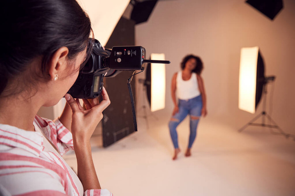 Model Posing For Female Photographer In Studio Portrait Session - 写真・画像