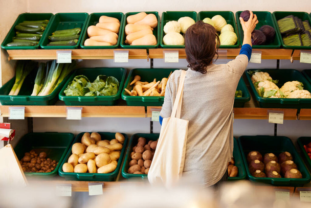 Rear View Of Female Customer Choosing Fresh Produce In Organic Farm Shop - Foto, Imagen