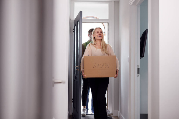 College Student Couple Carrying Boxes Moving Into Accommodation Together - Photo, image