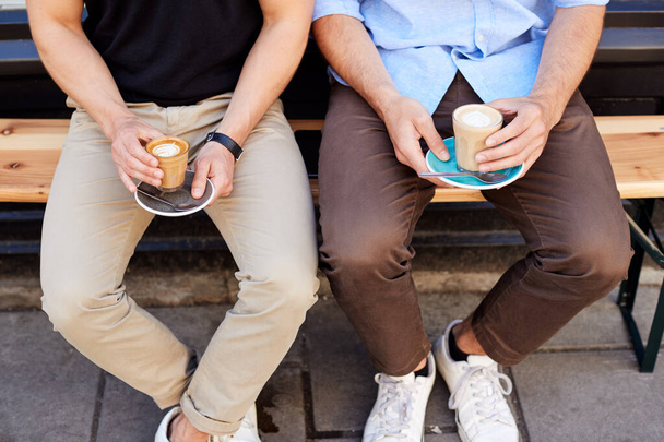 Close Up Of Two Men Sitting Outside Coffee Shop Drinking Coffee - Foto, immagini