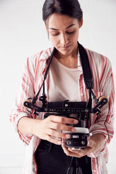 Female Crew Member On Video Film Set Operating Wireless Follow F - 写真・画像
