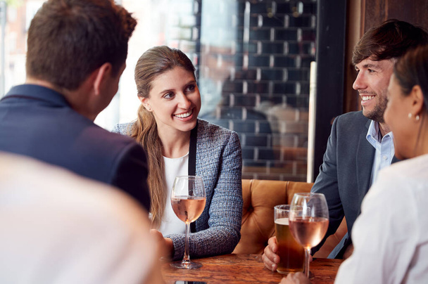 Group Of Business Colleagues Meeting For Drinks And Socializing In Bar After Work - Fotoğraf, Görsel
