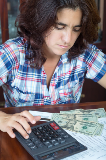 Latin woman counting money at home to pay the bills - Photo, Image