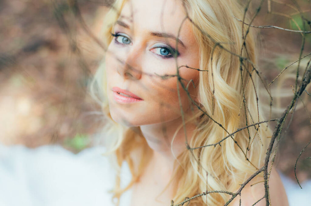 Portrait of young blond bride in forest - Photo, Image
