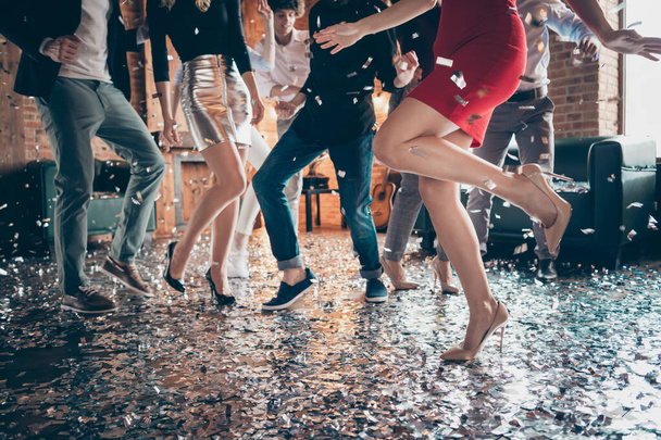 Cropped closeup photo of slim perfect legs girls guys meeting rejoicing dance floor x-mas party glitter flying wear formalwear red dress silver skirt pants restaurant indoors - Zdjęcie, obraz