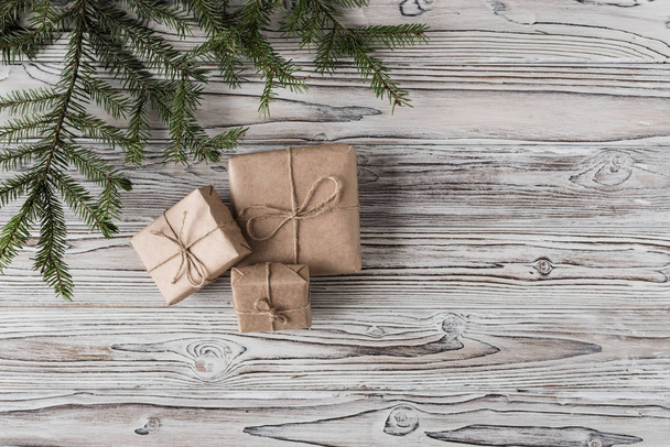 Handmade gifts made from craft paper christmas rope and tree on the rustic wood planks background. DIY. - Fotó, kép