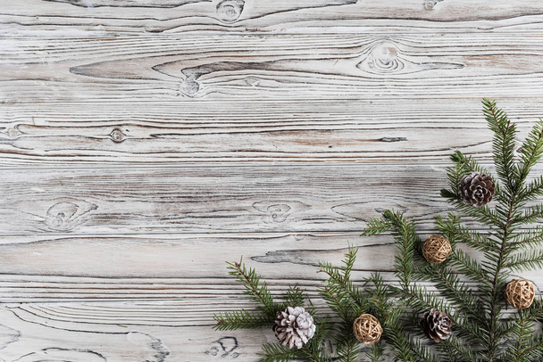ramas de abeto, árbol de Navidad, conos y decoraciones en madera rústica marrón, tablones quemados blancos y grises. Año Nuevo. Piso tendido, vista superior
.  - Foto, imagen