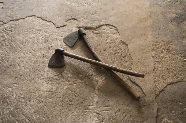 Old lumberjack axes on rustic floor - Photo, Image