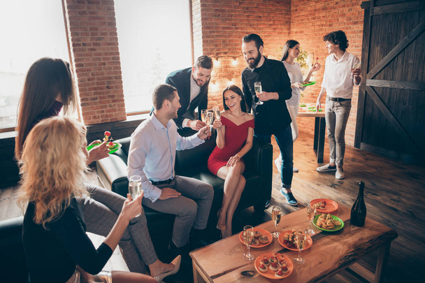 Photo of positive festive birthday party people friendship chatting clinking glasses drink golden wine eating snacks wear formalwear sitting sofa loft room indoors - Photo, Image
