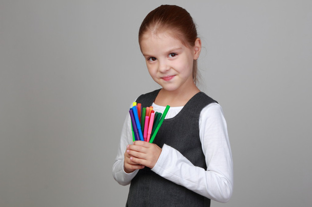 Cute schoolgirl holds a pencils - Foto, Bild