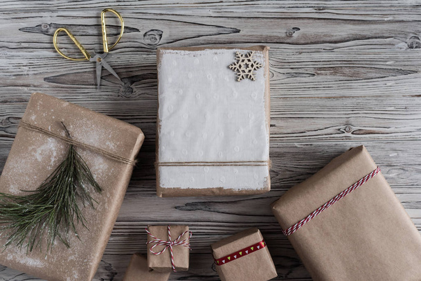 Handmade gifts made from craft paper christmas rope and tree on the rustic wood planks background. DIY. - Foto, Imagem