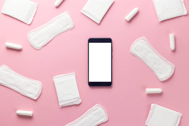 Tampons, feminine sanitary pads and gadget on a pink background. Hygienic care on critical days. menstrual cycle. Caring for womens health. Monthly protection. Flat lay, top view, copy space - Φωτογραφία, εικόνα