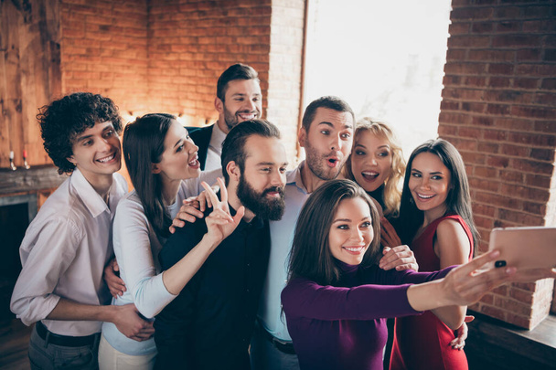 Portrait of nice attractive positive friendly cheerful cheery glad people company enjoying festal meeting making selfie showing v-sign at modern industrial brick loft style interior house indoors - Zdjęcie, obraz