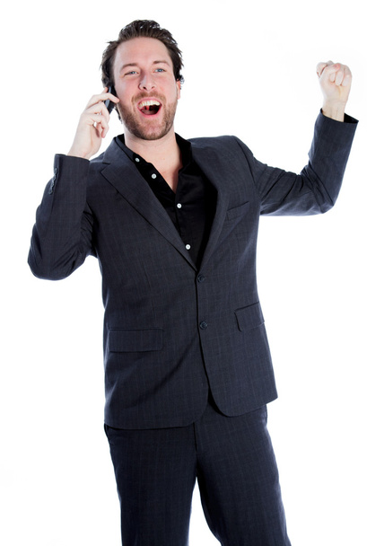 Привабливий кавказький щасливий бізнесмен розмовляє по телефону
 - Фото, зображення