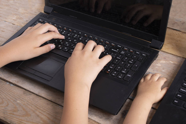 Boy typing on keyboard, baby wathing cartoon - Photo, Image