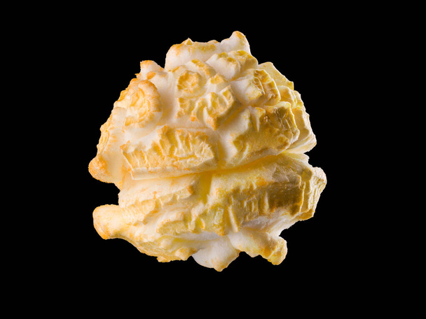 Single popped popcorn on a black background. Close-up or macro with clipping path - Fotoğraf, Görsel