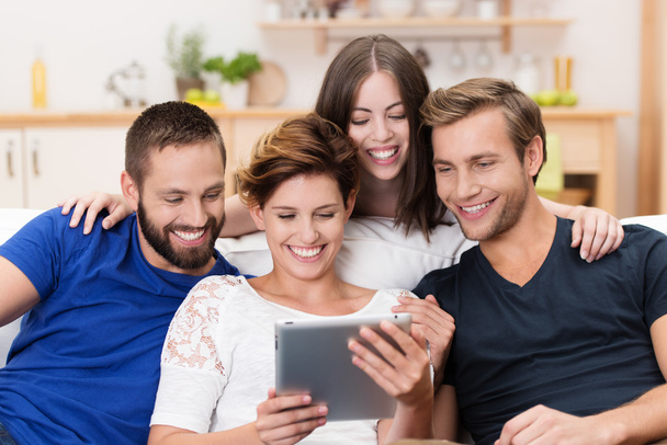 Group of happy friends sharing a tablet - 写真・画像