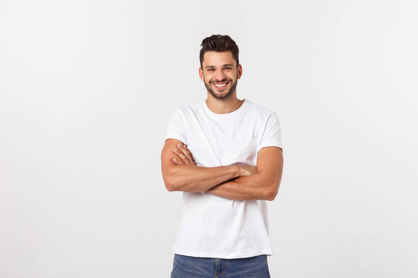 Portrait of a handsome young man smiling against white background - Photo, image