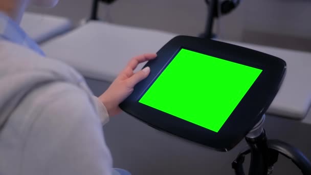 Green screen concept - woman looking at display of floor standing tablet kiosk - Footage, Video
