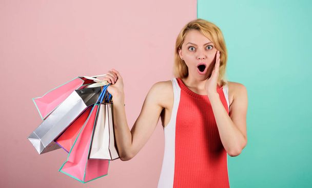 Discounts and loyalty program. Real sale. Woman on shopping tour. Retail and consumerism. Ecology impact. Satisfied with her shopping. Girl with paper bags. Black friday concept. Happy shopping day - Foto, afbeelding