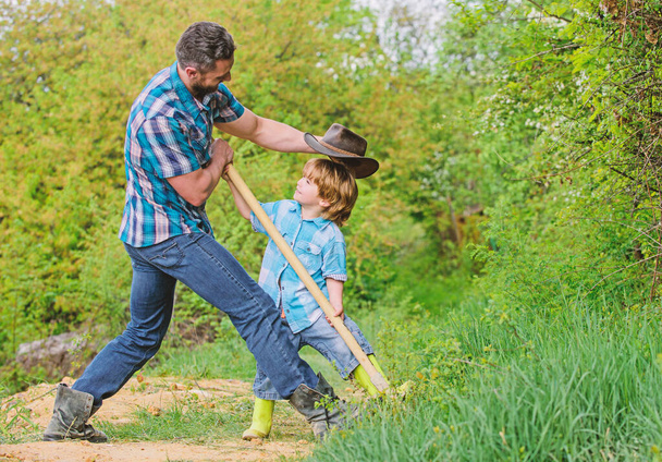 Cute child in nature having fun cowboy dad. Find treasures. Little boy and father with shovel looking for treasures. Spirit of adventures. Adventure hunting for treasures. Little helper in garden - 写真・画像