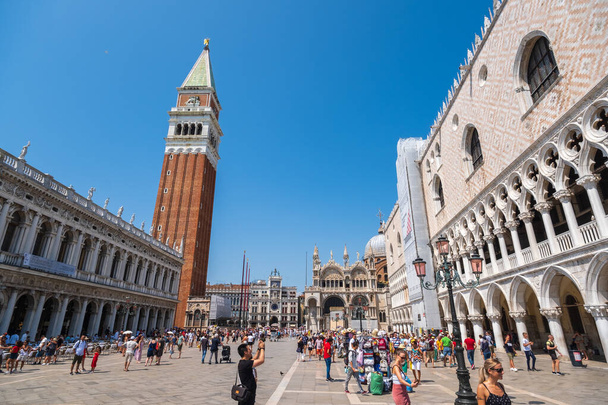 Tourists sightseeing in Venices most famous square San Marco - Photo, Image
