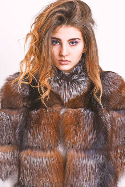 Woman makeup calm face hair volume hairstyle. Winter hair care tips you should follow. Hair care concept. Girl fur coat posing with hairstyle on white background close up. Prevent winter hair damage - 写真・画像