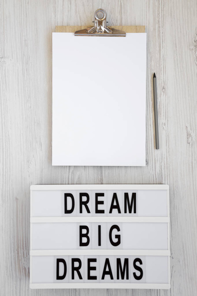'Dream big dreams' words on a lightbox, clipboard with blank she - Fotografie, Obrázek