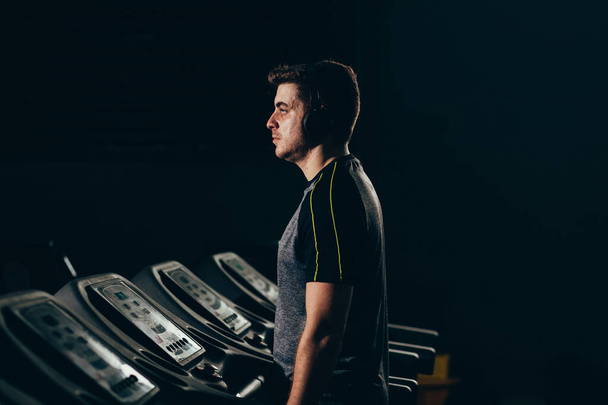 Lonely man running on treadmill at the gym - Foto, Bild