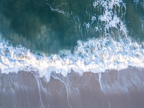 Drone picture of waves hitting the beach. - Фото, зображення