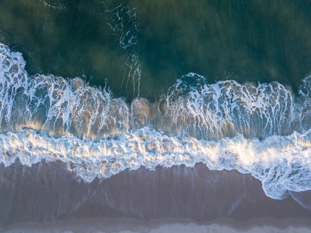 Drone picture of waves hitting the beach. - Fotoğraf, Görsel