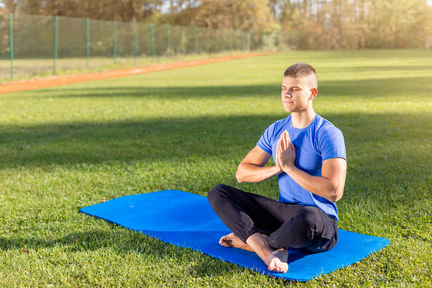 Man in park doing yoga - Фото, зображення