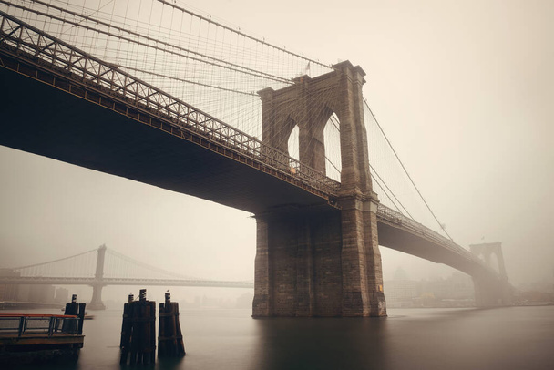 Brooklyn Bridge in a foggy day in downtown Manhattan - Photo, Image
