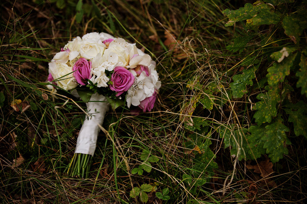Wedding bouquet in the grass in the forest - Fotó, kép