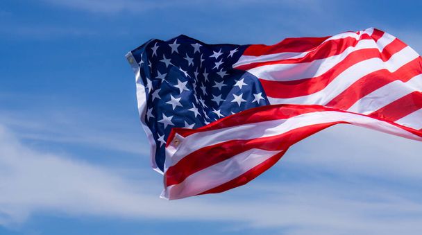 US American flag on blue sky background. For USA Memorial day, V - 写真・画像
