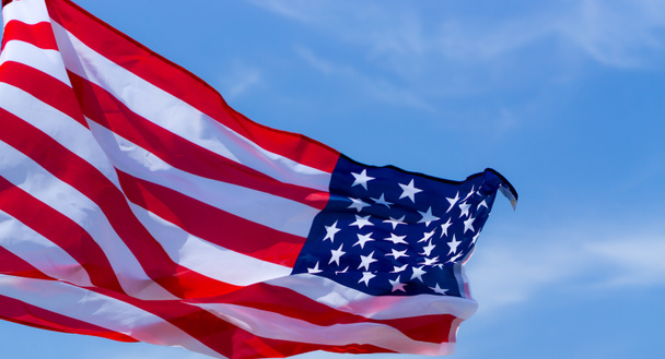 US American flag on blue sky background. For USA Memorial day, V - Foto, Imagen