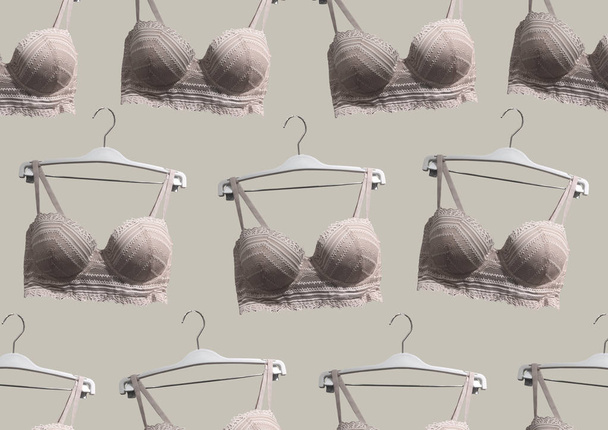 Lace bras on a hanger isolated on brown background. Textile, Underwear. Vintage White Lace Bras unlined lace detailing. Sexuality lingerie. Fashion concept. Stylish lingerie. Set of female underwear - Photo, Image