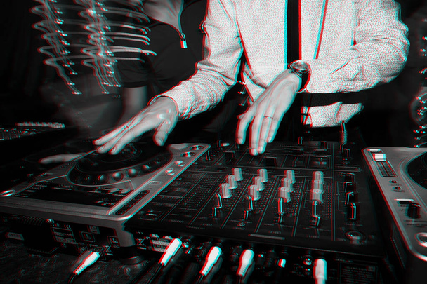 Hands DJ playing music on a professional mixer Board in a nightclub at a party close-up - Photo, Image