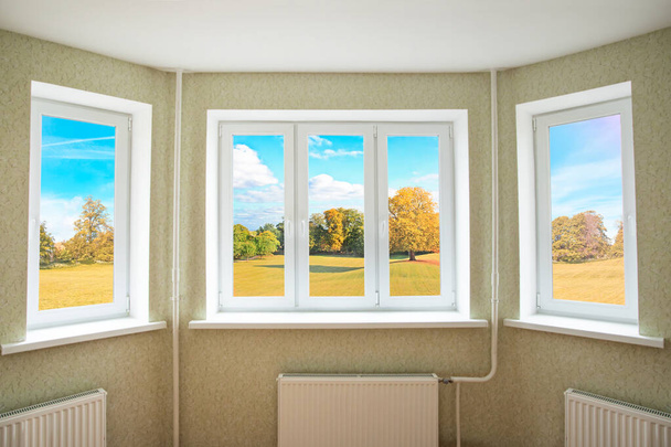 Vue à travers une fenêtre moderne en PVC sur un beau paysage d'automne
  - Photo, image