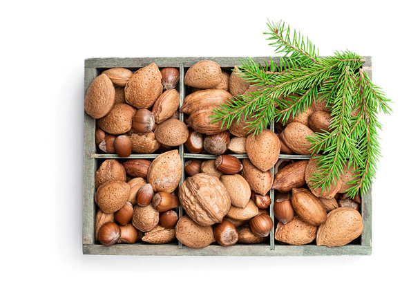 Wooden box with mixed nuts isolated on white. Christmas set.  - Foto, imagen