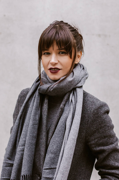 Young caucasian woman wearing grey coat and scarf - Photo, Image