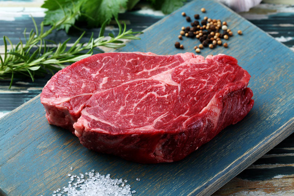 raw meat beef steak on green rustic table - Foto, imagen